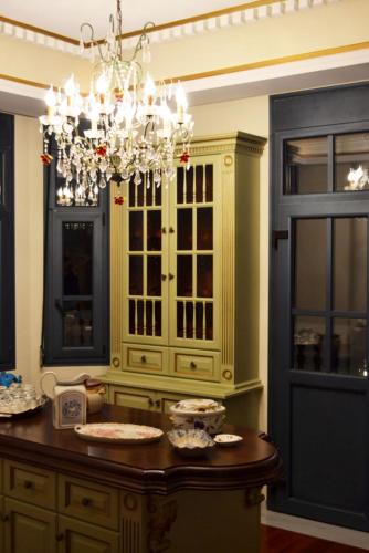 a kitchen with a chandelier and a wooden table at Mikamas Villas in Pyrgi Thermis
