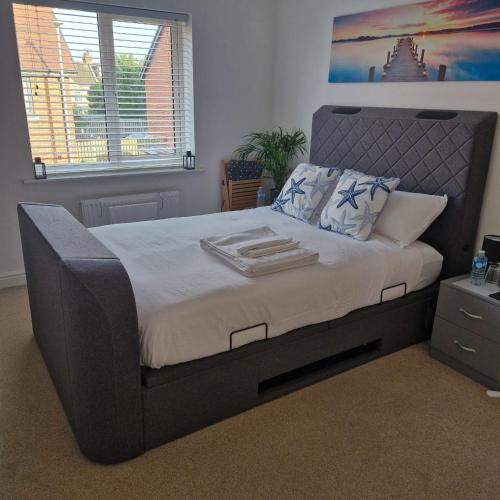 a bedroom with a large bed in a room at The Lancers, Cheriton, Kent - Modern Double Room with En-Suite, Parking & Fast WiFi - Close to Channel Tunnel in Kent