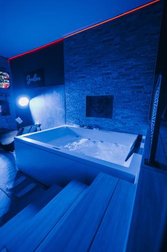 a large bath tub in a room with a brick wall at Sweetlove Spa in Terracina