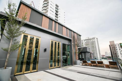 a building with glass doors in a city at Arte Hotel - SHA Extra Plus in Bangkok