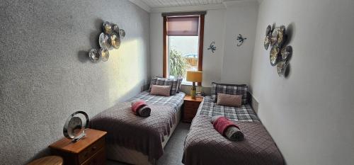 a room with two beds and a window at Westview in Buckie