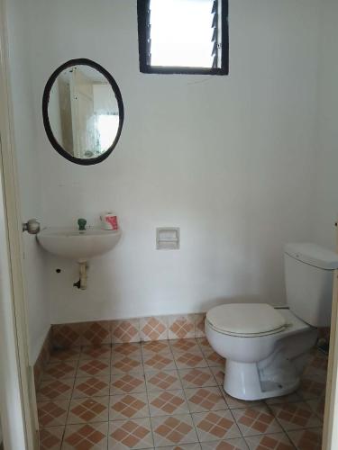 a bathroom with a toilet and a sink at Villa Rosita - Apo Island in Dauin
