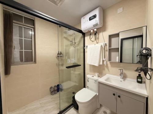 a bathroom with a shower and a toilet and a sink at Damao Holiday shanghai pvg 24hFREE shuttle bus in Shanghai