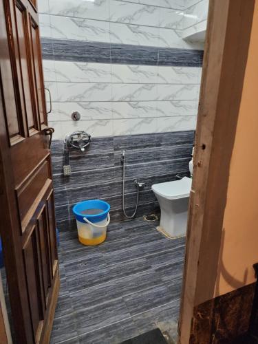 a bathroom with a toilet and a bucket at The moon Guest House in Jodhpur