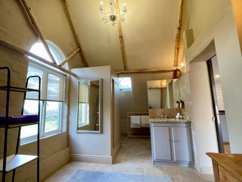 a bathroom with a sink and a mirror at Heuwelsig Farm Cottages in Franschhoek