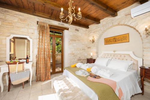 a bedroom with a large bed in a stone wall at Villa Marcos Chara in Astérion
