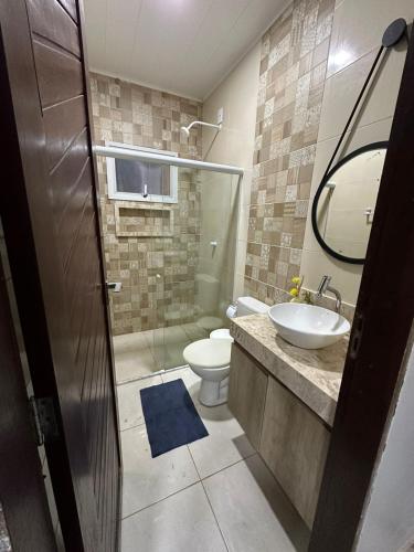 a bathroom with a toilet and a sink at Casa Maresia Ponta da Asa in Coruripe