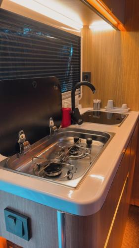 a kitchen with a stove and a sink at Vadi Karavan Otel in Buca
