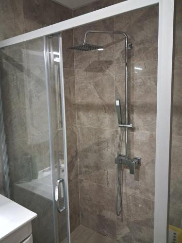 a bathroom with a shower with a glass door at Onix 1 in Soko Banja