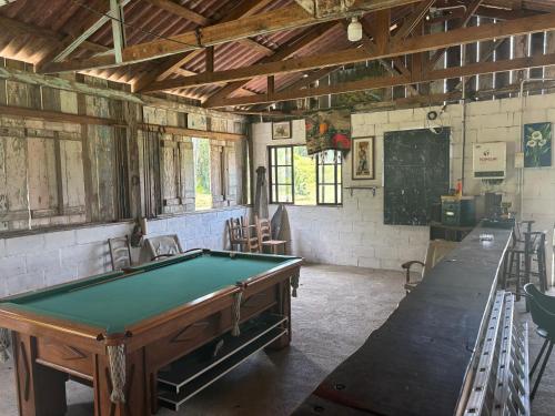 a room with a pool table and a chalkboard at Camping Fazenda Serramar in Palhoça