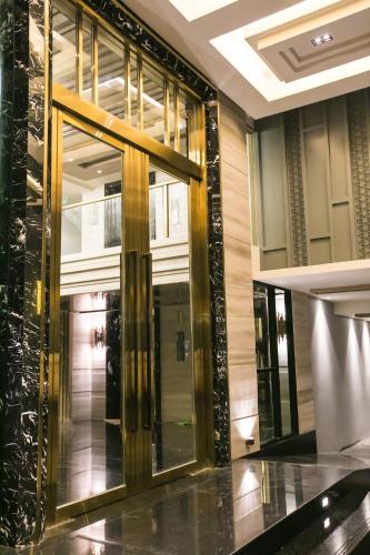 a lobby with a revolving door in a building at Arte Hotel - SHA Extra Plus in Bangkok