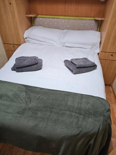 a bed with two towels on top of it at Oak House Laois B&B in Portarlington