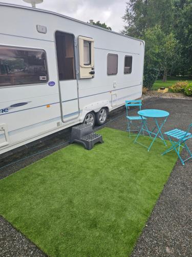 a white trailer with a table and a picnic table at Oak House Laois B&B in Portarlington