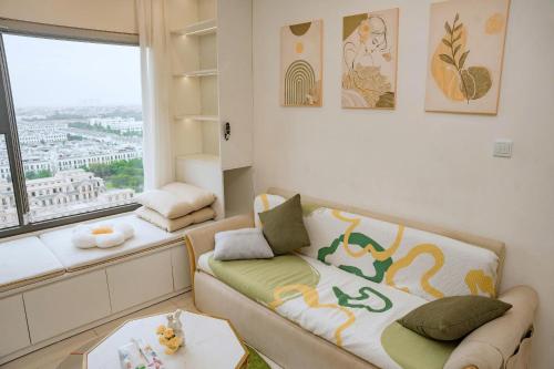 a living room with a couch and a window at Home MinMimi in Gia Lâm Pho