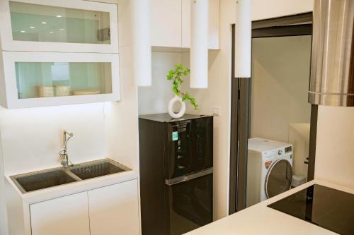 a kitchen with a sink and a washing machine at Home MinMimi in Gia Lâm Pho