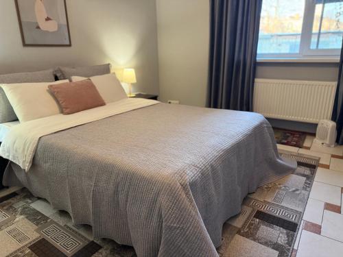 a bedroom with a large bed with a large window at Odessa Guest House-City Center in Chişinău