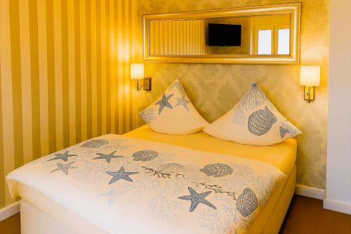 a bedroom with a bed with two pillows on it at Villa Meeresglück in Sassnitz