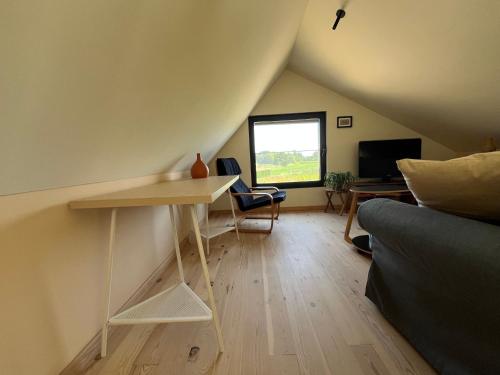 a living room with a table and a couch at Bellefleur Cottage in Herent