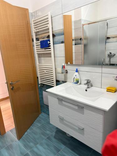 a bathroom with a sink and a mirror at Apartaments Shengjin with sea view in Shëngjin