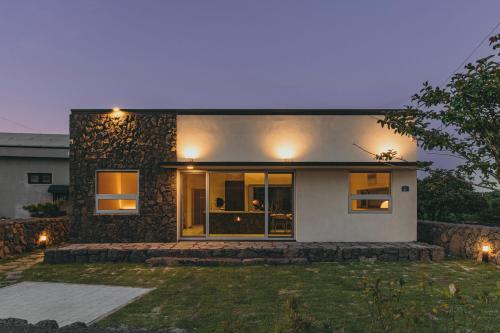 a house with lights on the front of it at 제주 이루후제 in Jeju
