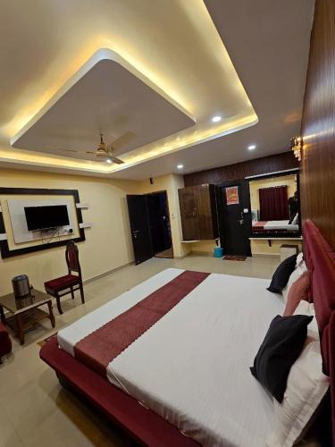 a bedroom with a large bed in a room at VR Palace in Kānpur