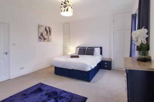 a bedroom with a bed and a vase of flowers at town house in Northampton