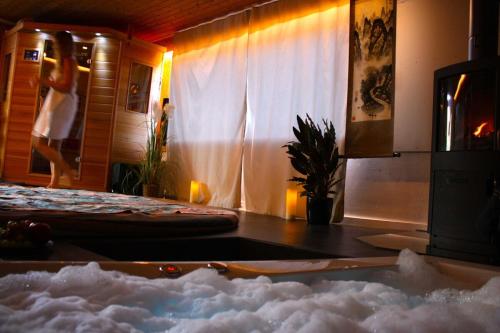 a room with a table with a snowboard in front of a window at La Schaumauna, privater Spa in Oberkirch
