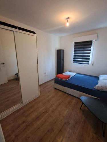 a bedroom with a bed and a sliding glass door at Obtsinsky Beach in Haifa