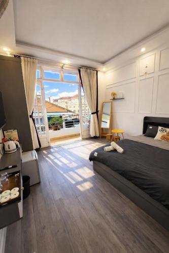 a bedroom with a bed and a large window at Thanh Anh Hotel Da Lat in Da Lat