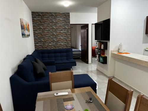 a living room with a blue couch and a table at Departamento Paty in Tampico