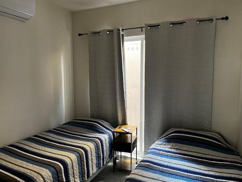 two beds sitting next to each other in a room at Departamento Paty in Tampico