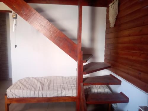 a bunk bed and stairs in a room at Entre aromos y lavandas in San Clemente del Tuyú