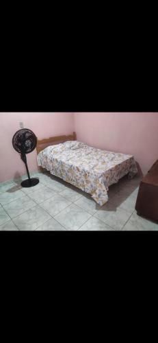 a bedroom with a bed and a table in it at AjuruLima in Bragança
