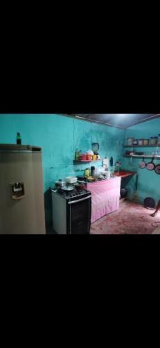 a kitchen with a stove top oven in a room at AjuruLima in Bragança