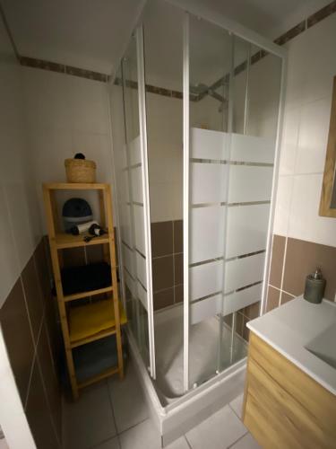 a shower with a glass door in a bathroom at Meuble maison vigneronne in Saint-André-de-Sangonis