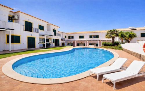 a swimming pool in the backyard of a villa at Casa Da Luz 18 - swimming pool and beach Town house in Luz