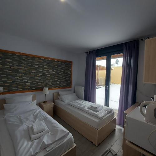 a bedroom with two beds and a window at Andromachi Apartments in Jembke