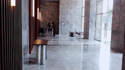 a man is standing in a room with a lobby at 2br Luxury apartment in Jakarta