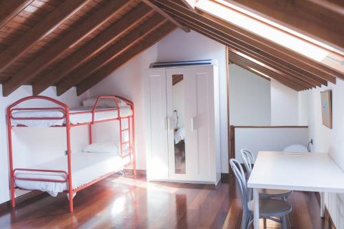 a room with two bunk beds and a table at La 68 in Santa Brígida