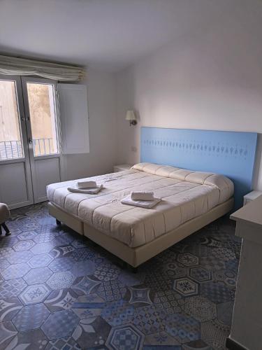 a bedroom with a large bed in a room at Locanda B&B Dandana in Orgosolo