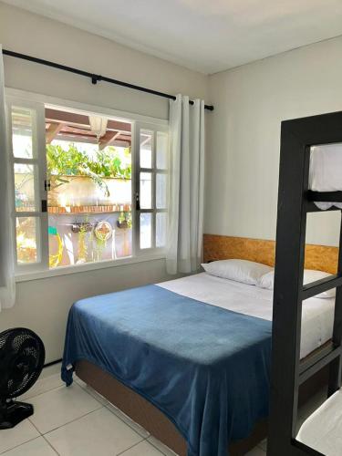 a bedroom with a bed and a window at BC Bier Hostel in Balneário Camboriú