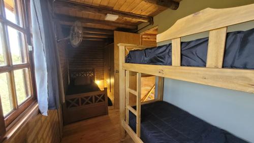 a room with two bunk beds and a door at Cabañas Sacha Huasi in Travesía
