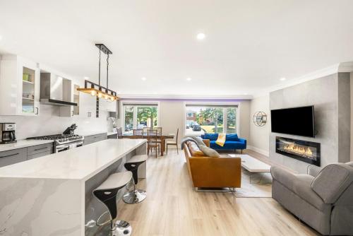 a kitchen and living room with a fireplace at 5 Bedroom Luxury Spa Escape with Pool & Jacuzzi in Toronto