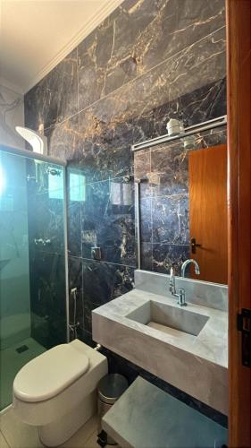 a bathroom with a sink and a toilet at Pousada Cabana in Avaré