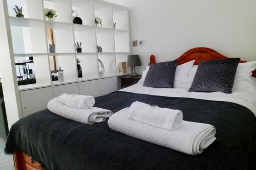 a bedroom with two beds with towels on it at The Mews & Studio in Ivybridge