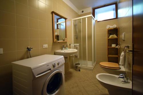 a bathroom with a washing machine and a sink at CasaInesAldo in Candide