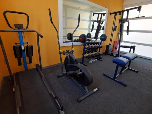 a gym with several exercise equipment in a room at Villa platino in Pachuca de Soto
