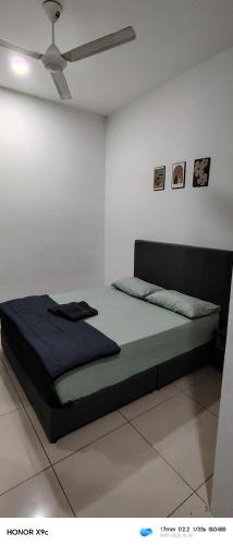 a bed in a white room with a ceiling at D'RailHouse65 in Gemas