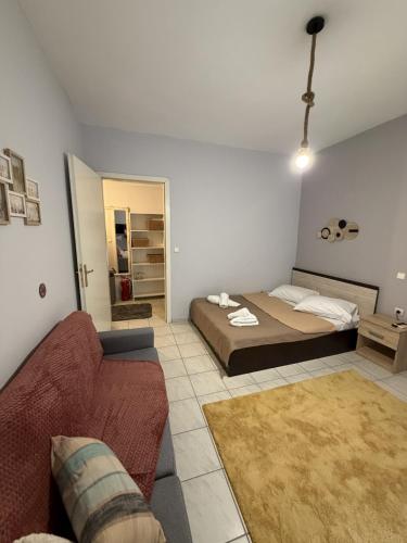 a living room with a bed and a couch at Dimi's home in Komotini