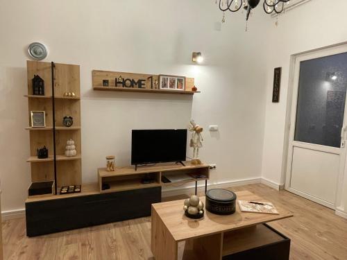 a living room with a television and a table at Dolce Vita in Belgrade